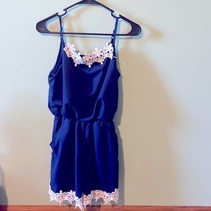 A dark blue jumper with a little bit of white trim on top and around the ends